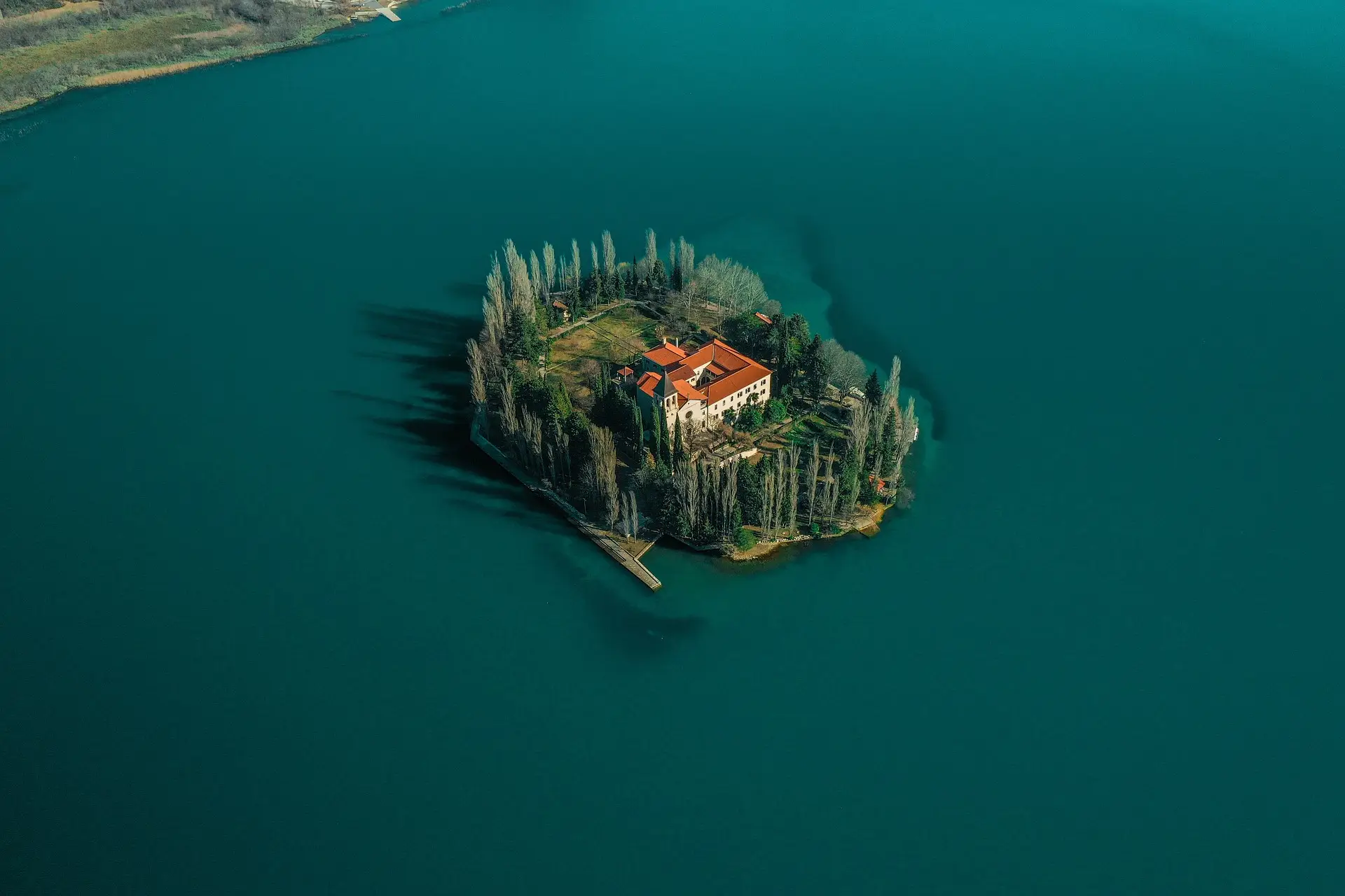 aerial view of an island in the middle of a lake