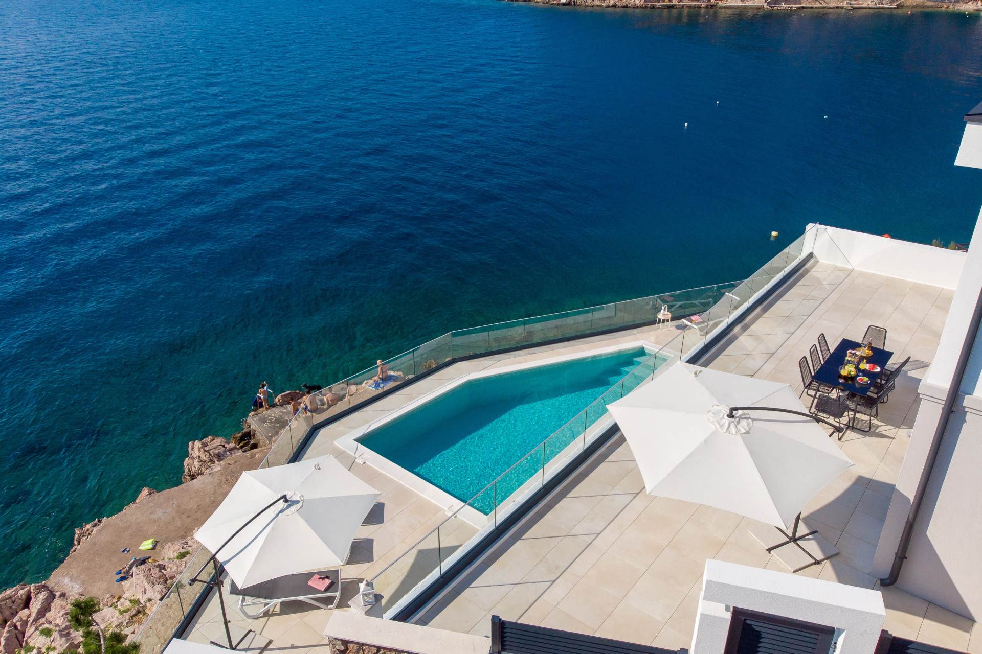 villa with a pool next to the sea