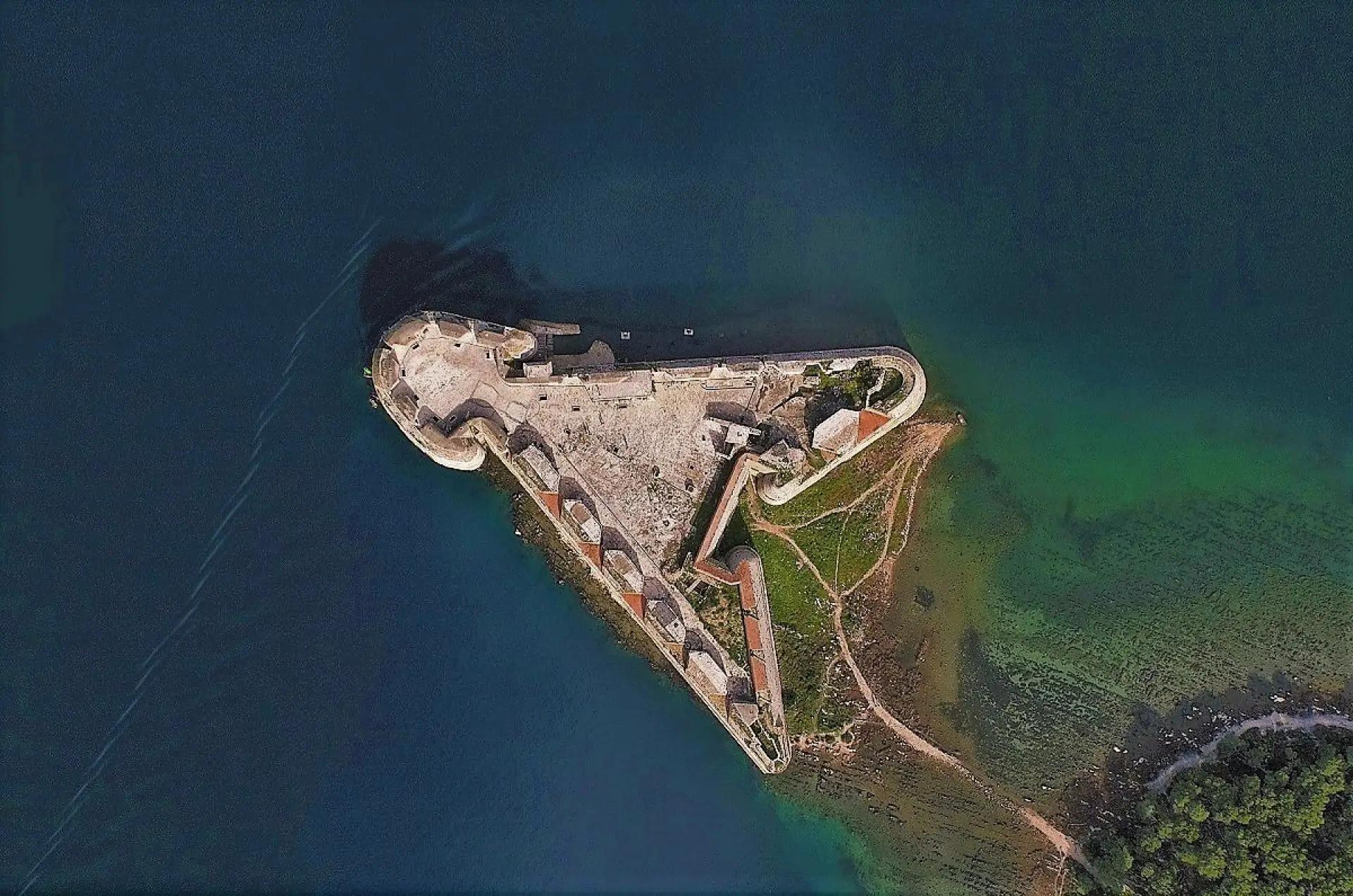 aerial view of a fortess surounded with the sea