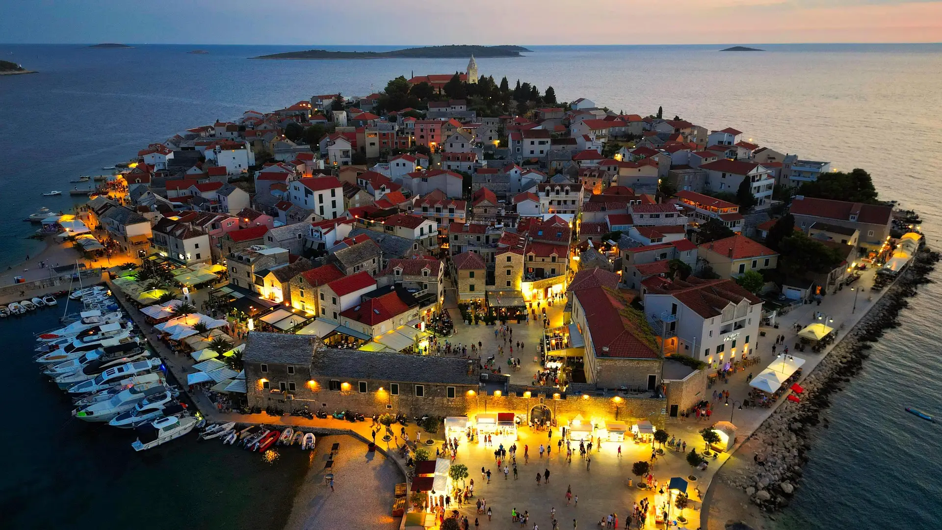 panoramic view of a coastal town by night
