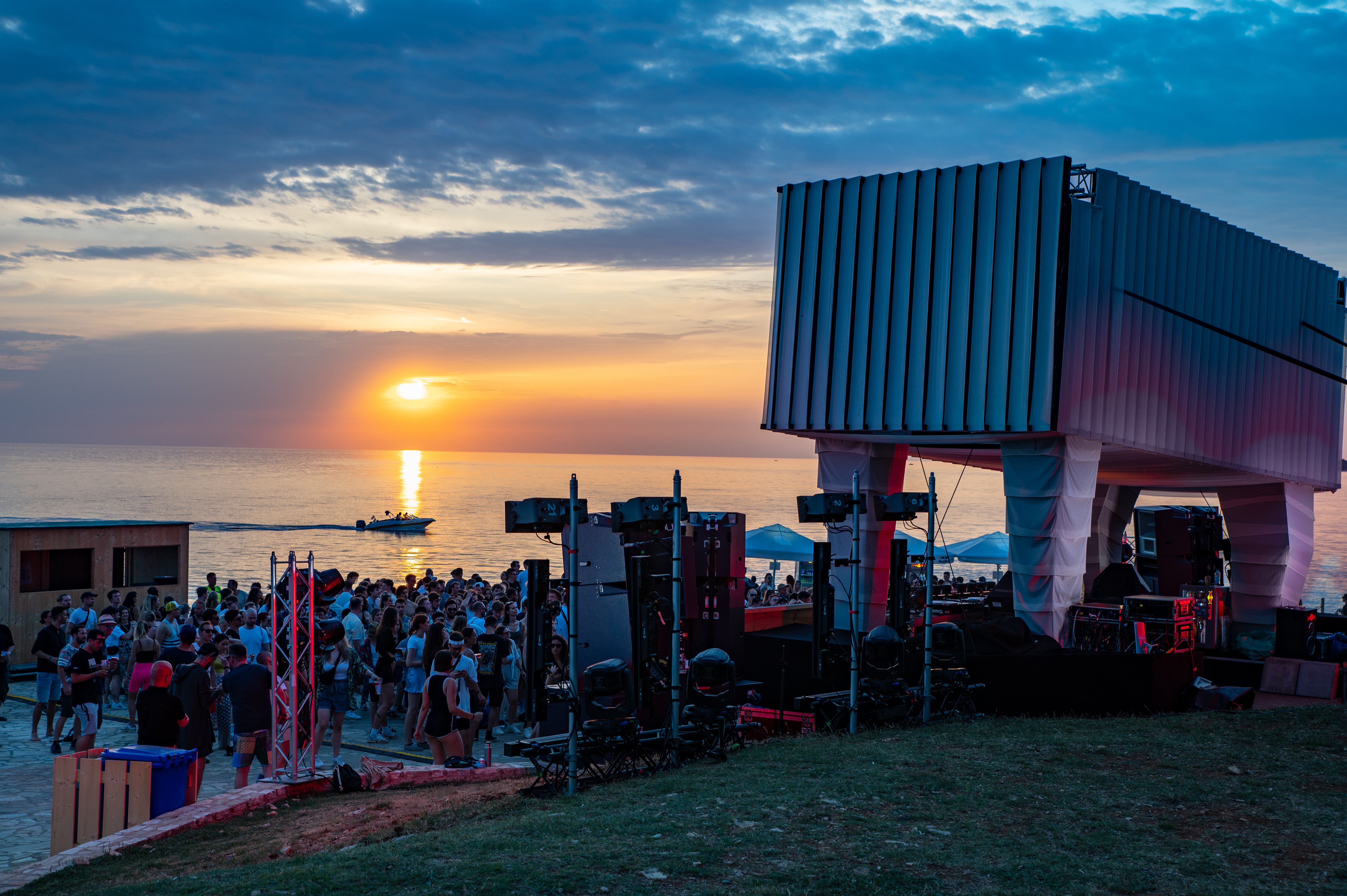 group of people dancing at sunset