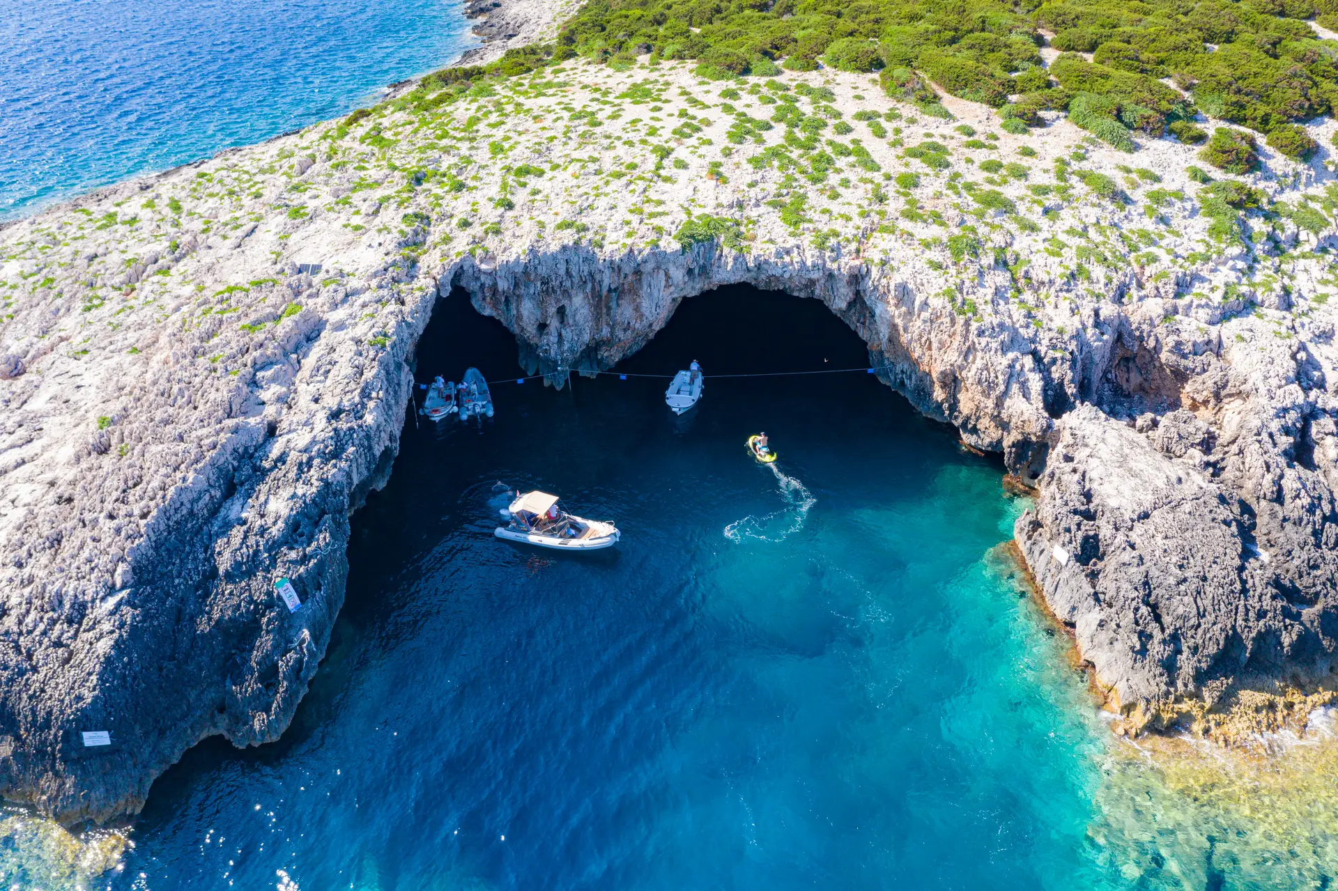 boats entering sea cave